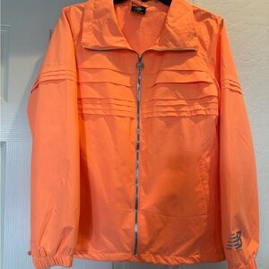 New Balance women's reflective running windbreaker in neon orange size medium